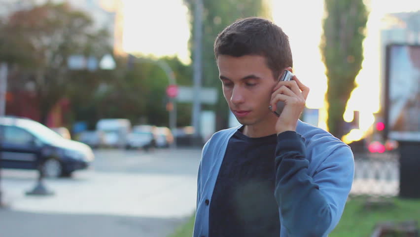Man calls dials number no answer serious young male outdoors day