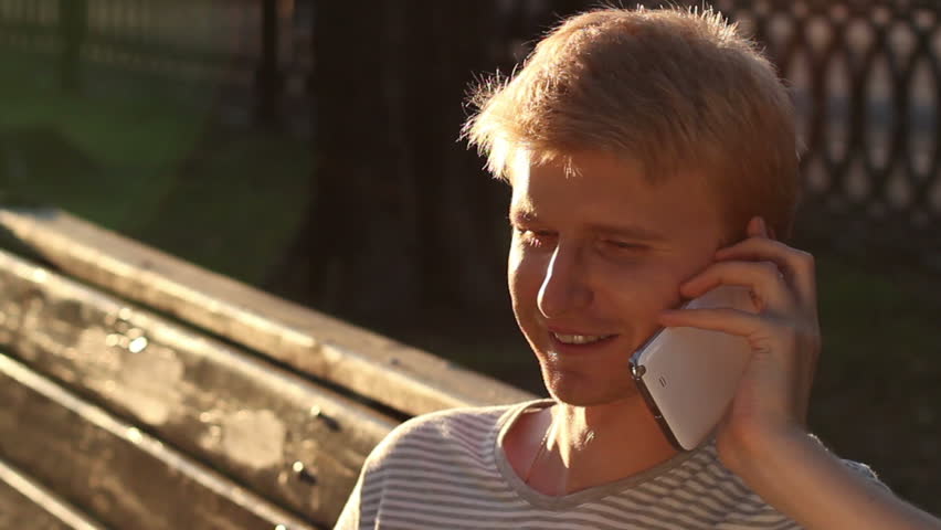 Happy young male calling over phone enjoying, good relationships