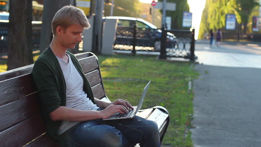 Man laptop turns seriously looks, success, victory, development