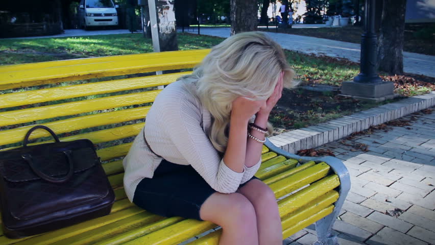 Depression and problems of blond female in park, crying tears