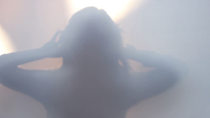 Slender slim silhouette of woman  moving turning touching hair