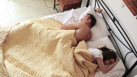 Couple having problems in bed, top view
