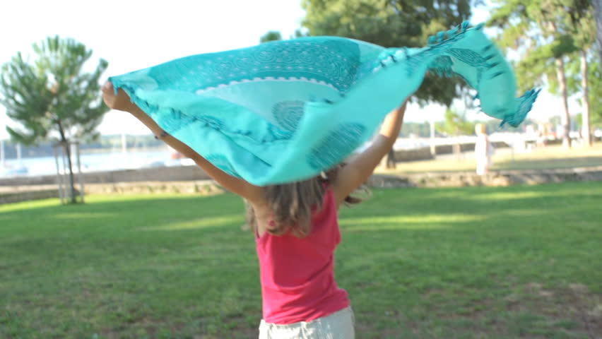 Slow Motion Shot Of A Cute Girl Shot In Her Back Running And Holding A Turquoise