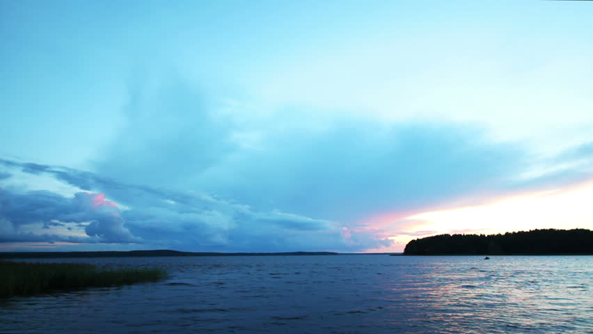 approaching storm on lake after sunset - timelapse