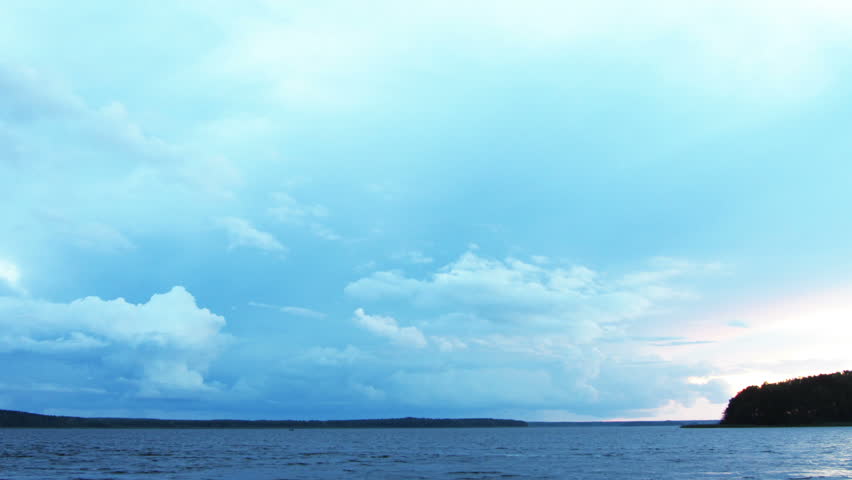 approaching storm on lake after sunset - timelapse