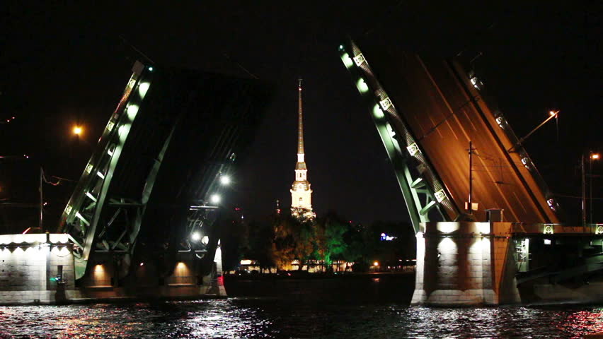ship under open drawbridge at night in St. Petersburg Russia