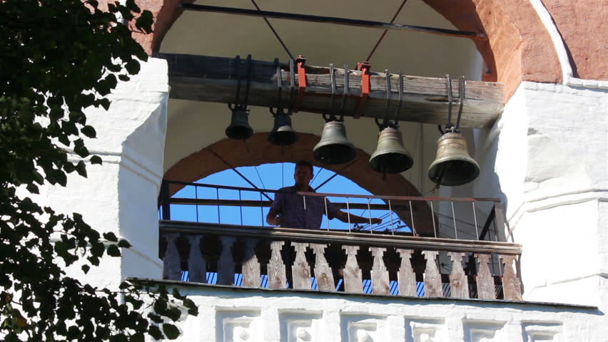 SUZDAL, RUSSIA - AUGUST 17, 2013: Ringer playing on bells on church tower in