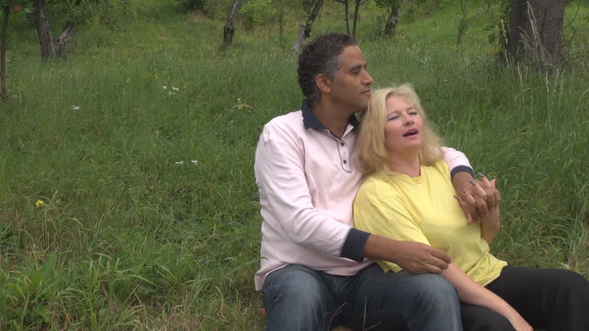 Romantic couple relax in garden during summer time
