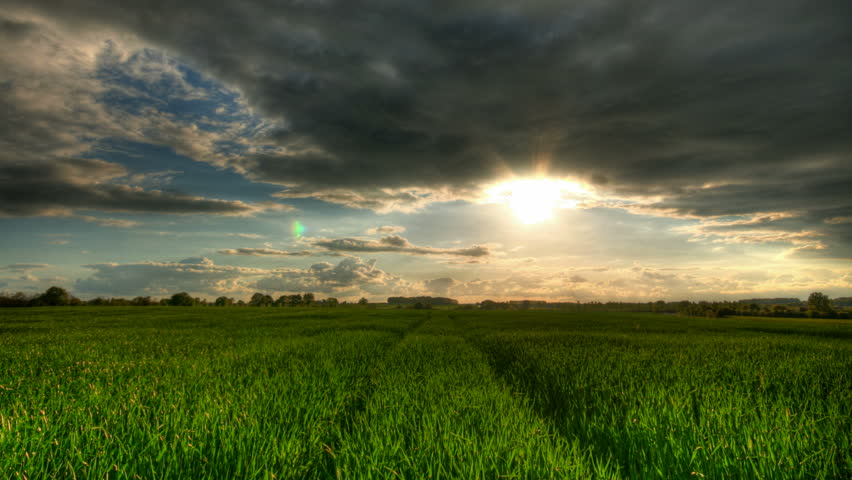 Sunset over green fields, HD time lapse clip, high dynamic range imaging