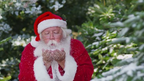 Santa Claus blowing snow off hands