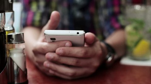Teenager hands texting on smartphone in cafe, steadicam shot

