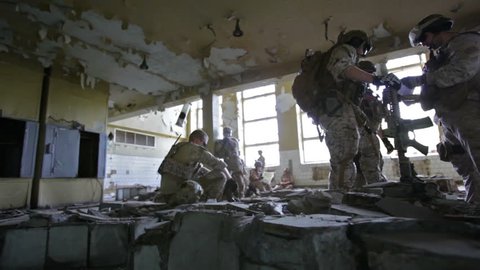 Militaries resting in a derelict shelter before setting off