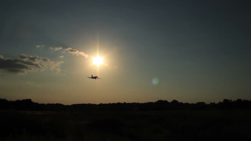 Dusk, airplane flying at sunset, silhouette basic. Business, success, traveling