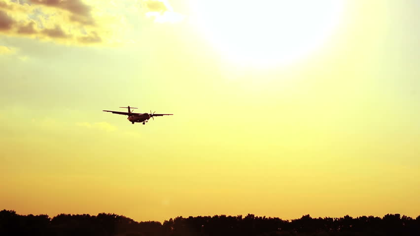 Beauty shot of the airplane flying at sunset
