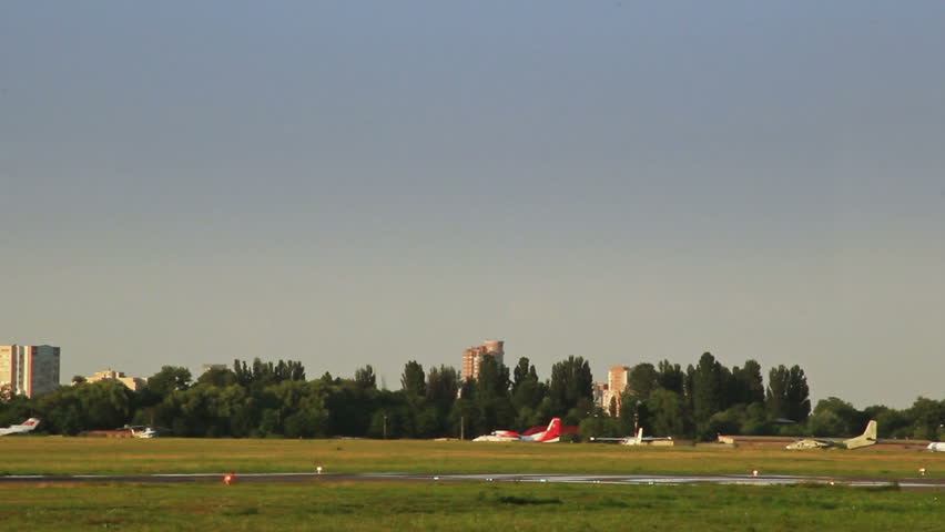 Jet takes off from the runway at sunset