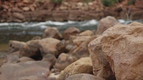 Rack focus from the rocks to the Colorado river in the Grand Canyon. 