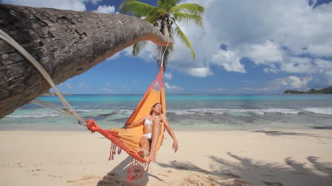 woman in hammock on palmtree