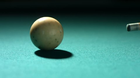 Closeup shot of cue ball being hit, slow motion