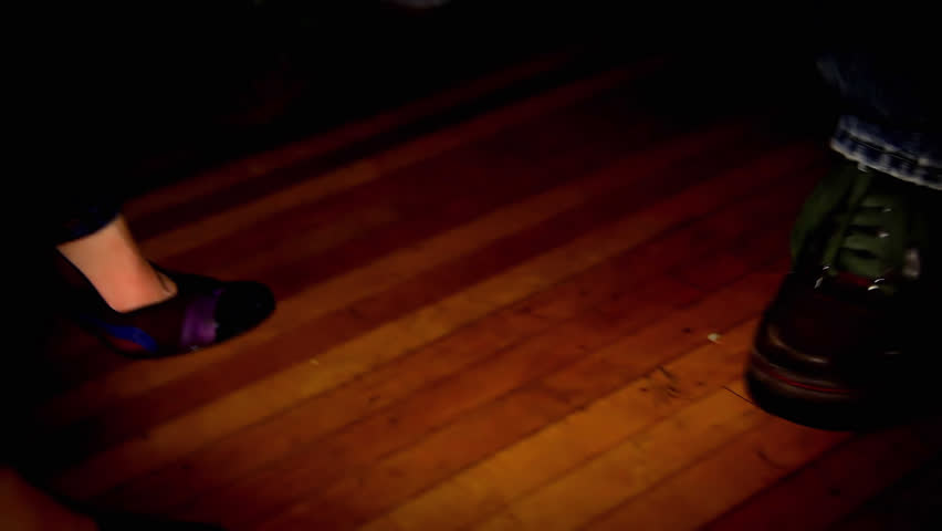 Close up of a couple dancing closely at on the dance floor of a house party