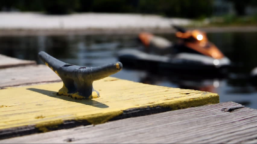A jet ski docked on a lake.  Shallow DOF.