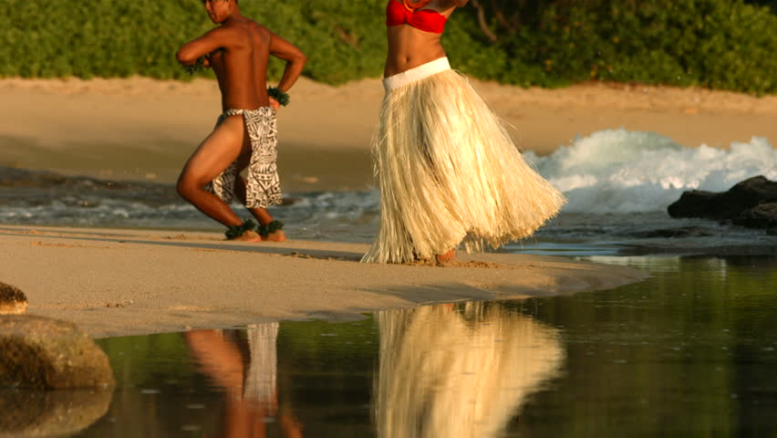 Polynesian dancers perform at beach in Hawaii, slow motion