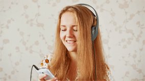 The girl listens to music, The young women likes to listen to music through headphones 