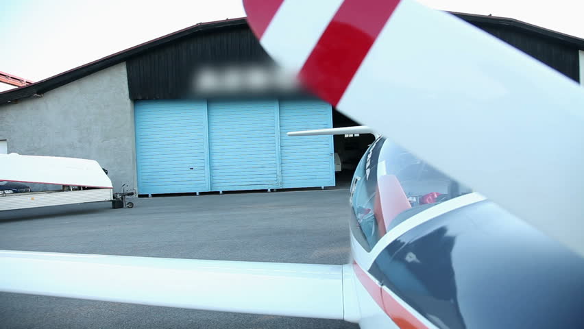 Two man coming from hangar ready for flight