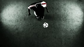 Skillful athlete juggles a soccer ball. Wide shot as seen from a high angle above