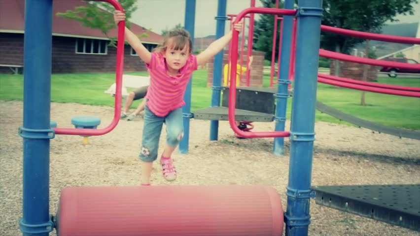 A little girl playing at the playground