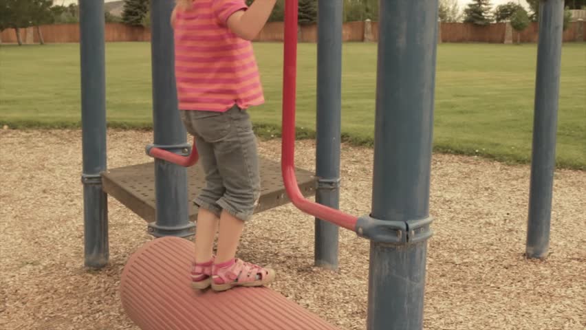 A little girl playing at the playground