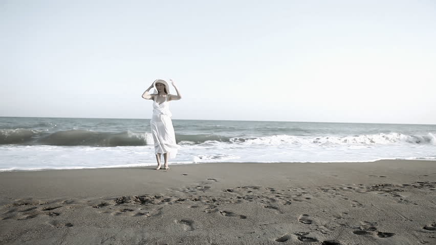 Young beautiful women in white on the beach