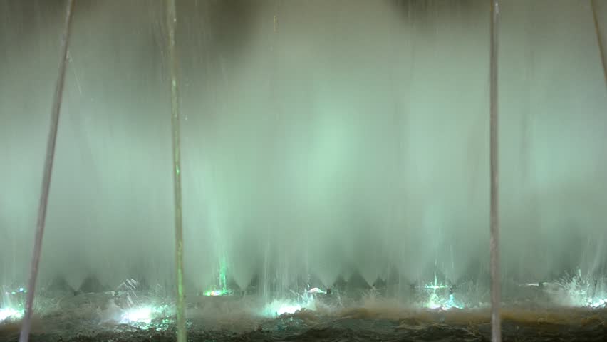 Abstract lit water fountain background of dancing forms.  Night shoot of water