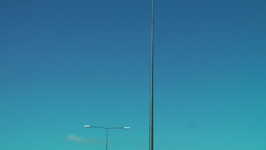 Motorway Lights in daytime against a beautiful blue sky background