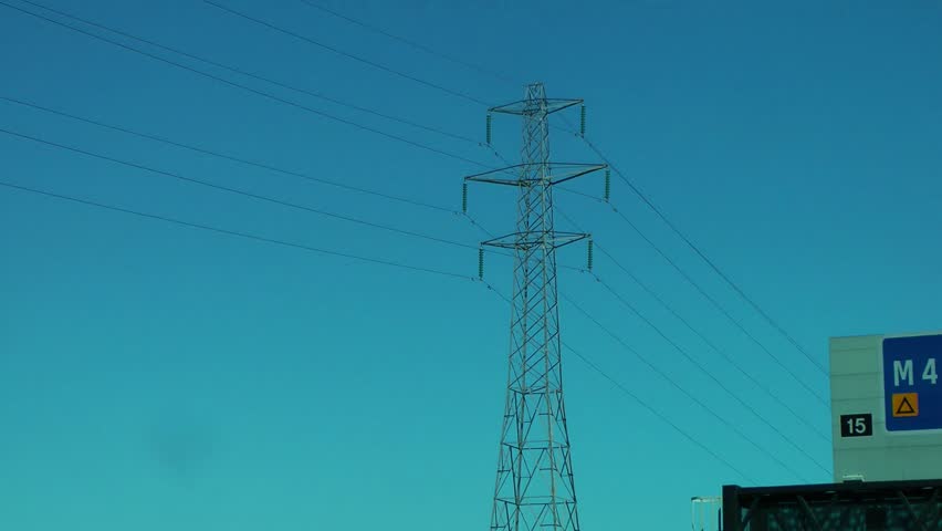 Electricity Pylons POV from car traveling along the highway against a beautiful