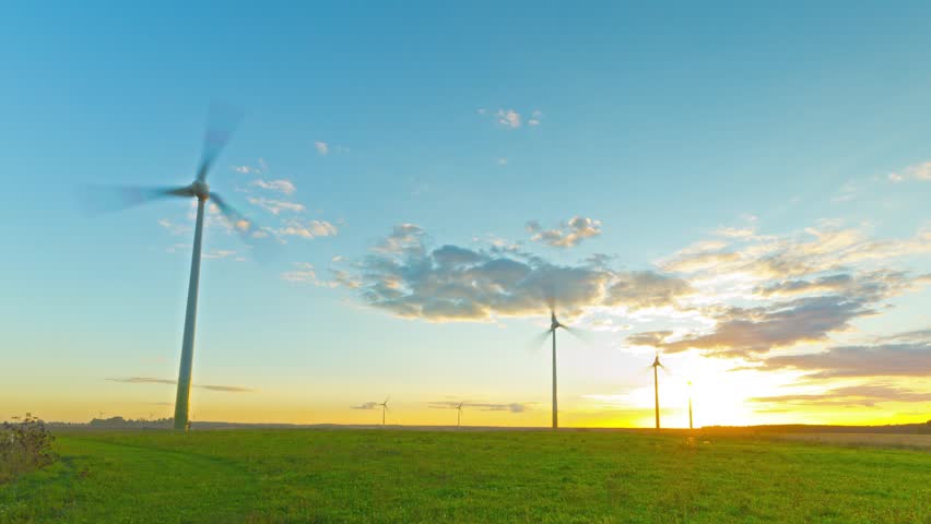 Windmills generators at sunset, time-lapse