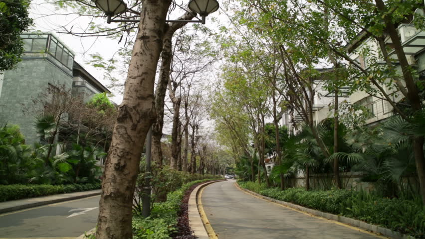 developing and rich china with houses in exclusive estate with transplanted trees and large car
