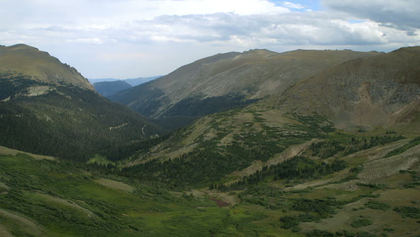Scene moves from a valley to a mountain ridge in Rocky Mountain National Park.