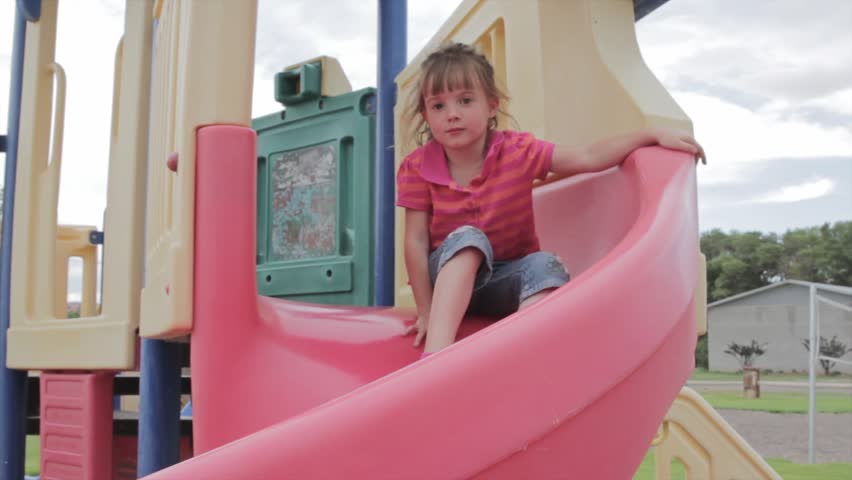 Children playing on a slide at the playground