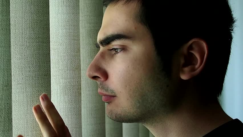Man looking outside a window