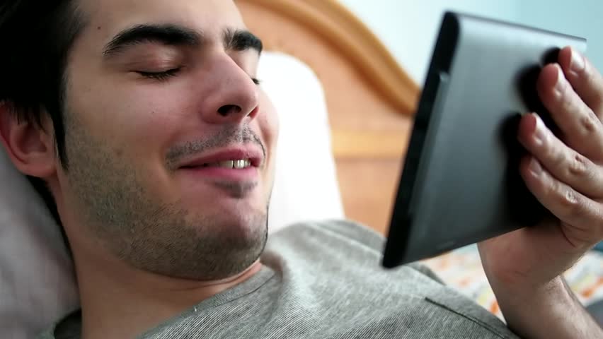 Man talks to somebody on a video call while in bed | Shutterstock HD Video #4614350