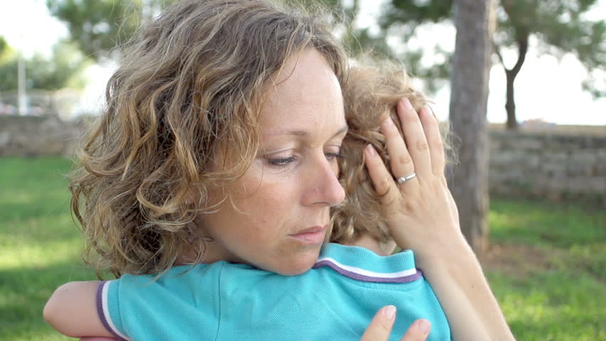 Slow Motion Shot Of A Mother Holding And Comforting Her Son. 