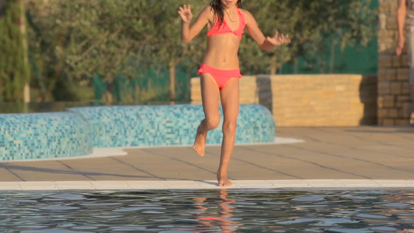 Slow Motion Shot Of A Sporty Young Girl Wearing Diving Mask And Jumping Into