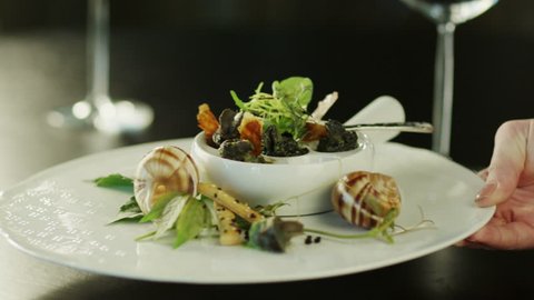 Serving Delicious Baked Escargots in Luxury Restaurant. Close-Up. Shot on RED Digital Cinema Camera in 4K (ultra-high definition (UHD), so you can easily crop, rotate and zoom, without losing quality. Stock Video