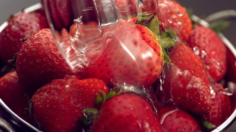 Rinsing strawberries in colander