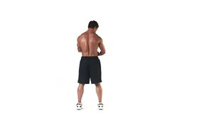 Wide shot of a muscular bodybuilder flexing his muscles with his back turned away from the camera on a white background