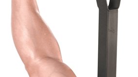 Close up of a muscular bodybuilder lifting a large, heavy barbell on a bench press on a white background, with a camera pan