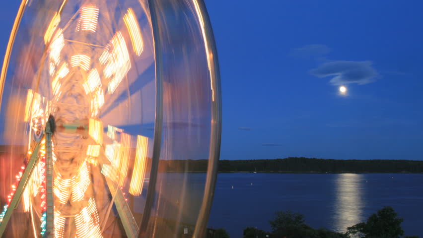 A time-lapse view of a ferris wheel on beautiful summer night in Maine.