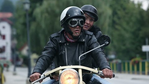 Middle aged couple enjoying the ride on retro motorcycle