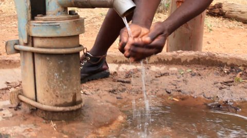African man getting water at bore hole