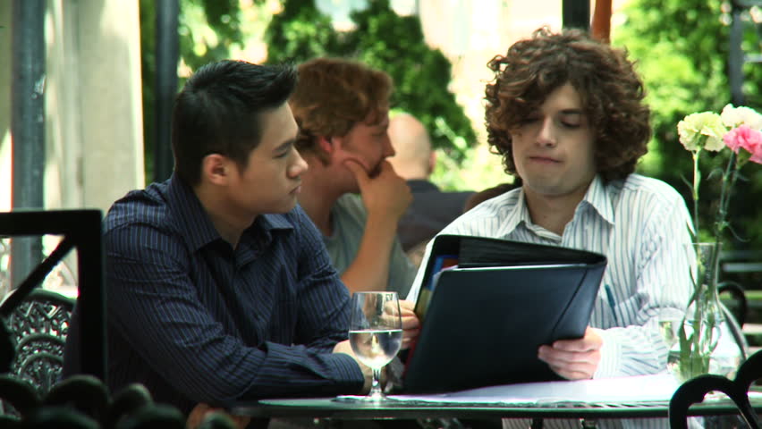 Two guys meet up for a business discussion at an outdoor location.